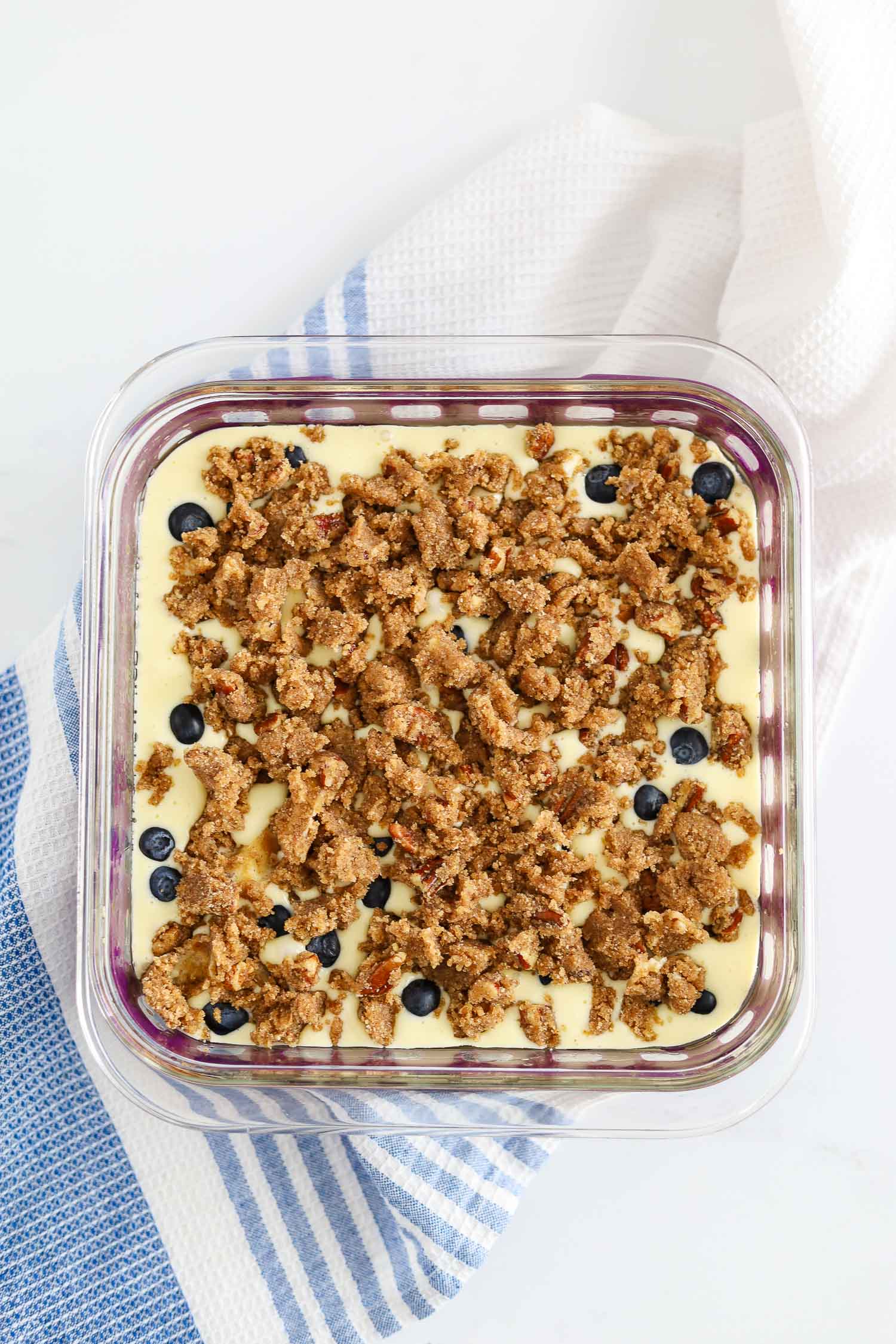 adding cinnamon pecan streusel over blueberries