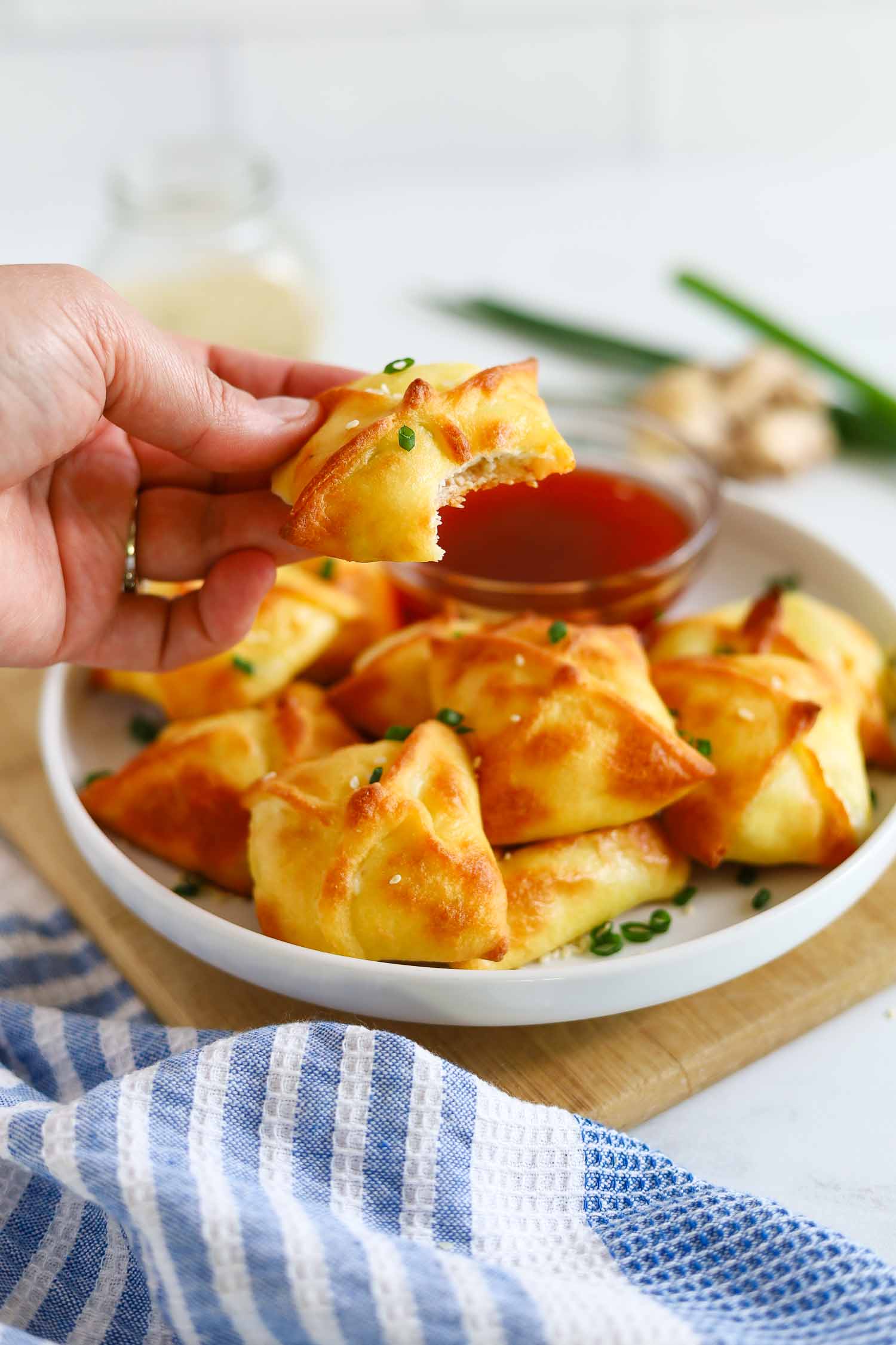 taking a bite out of a cheesy crab rangoon
